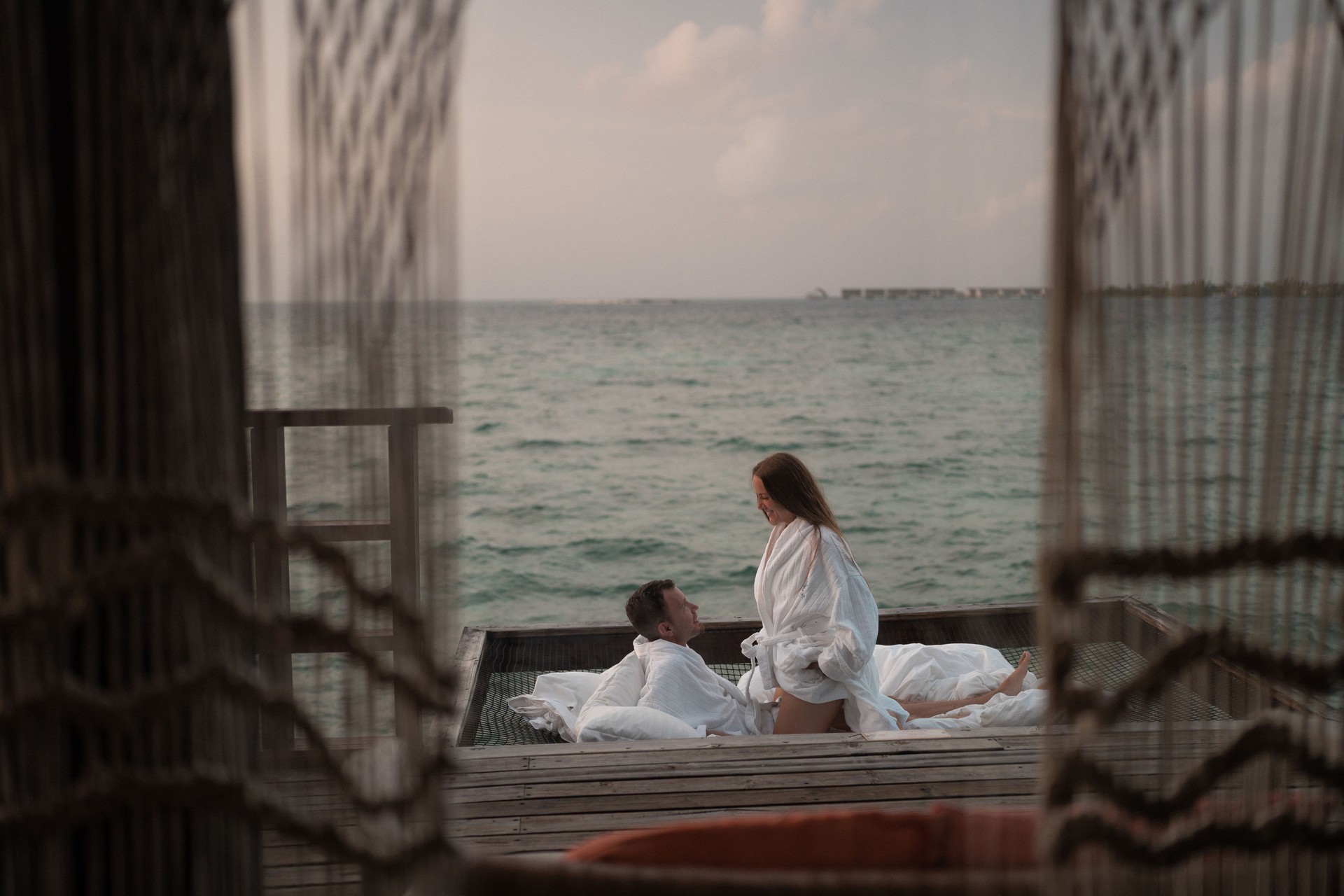 Newlyweds relax in a hammock in the Maldives